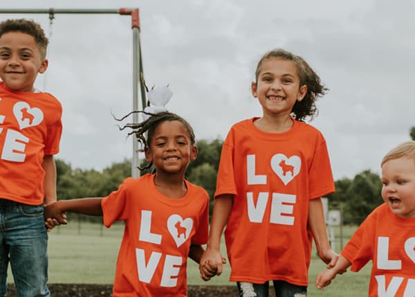 Kids wearing NextHome branded t-shirts with Luke