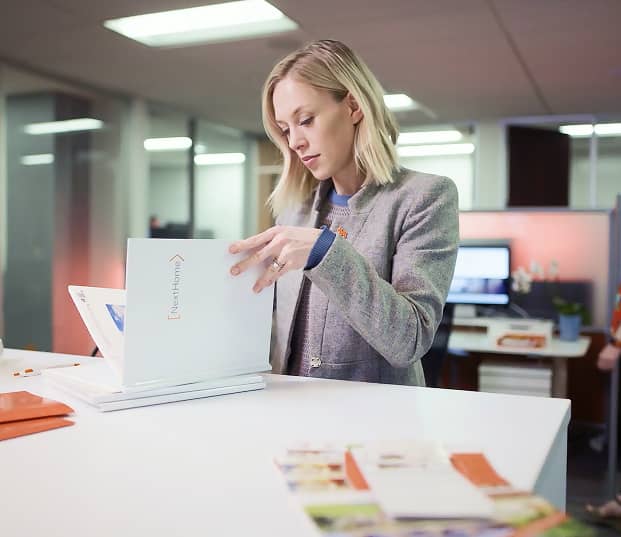 A woman looking through a NextHome listing presentation