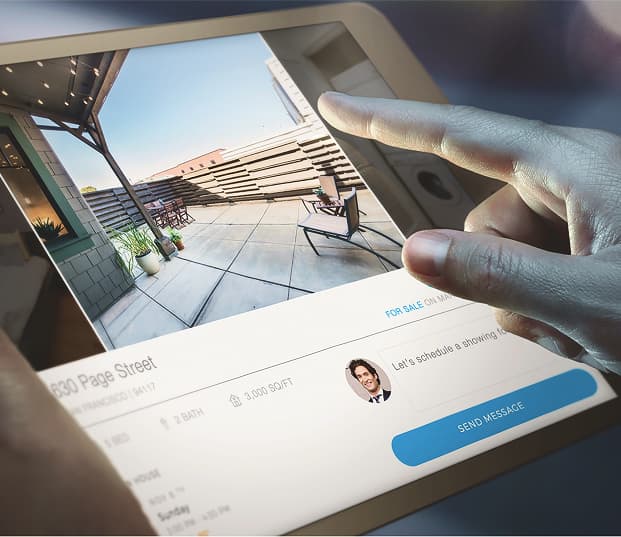 A close-up of someone looking at RealScout on a tablet.