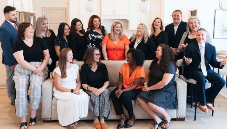 A group of NextHome real estate agents from an office