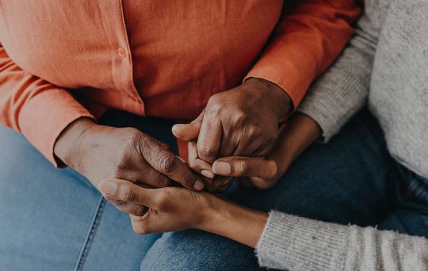a close up of a couple holding hands